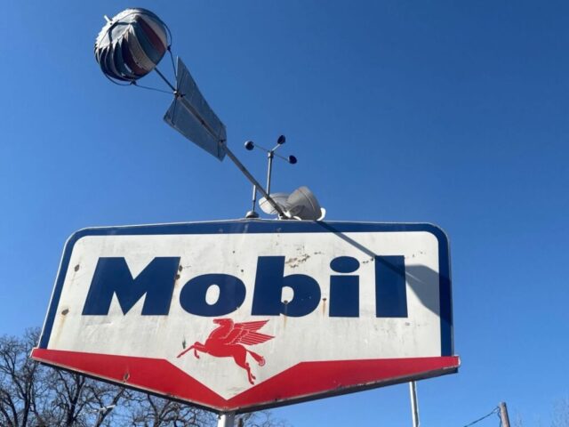 Vintage Mobil gas station porcelain sign with red Pegasus logo, classic petroleum advertising collectible