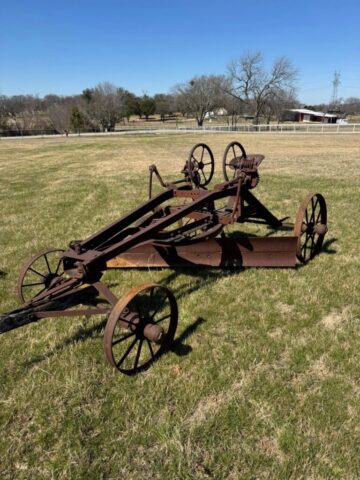 Antique pull-type road grader in public auction offered by Kiefer Auctioneers in Texas