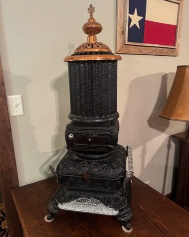 Antique cast iron parlor stove in upcoming online auction offered by Kiefer Auctioneers in Texas