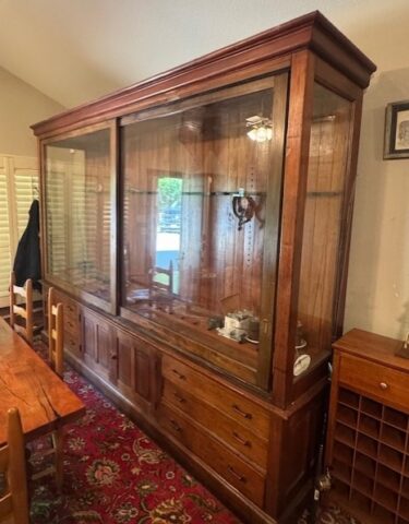 Antique wooden display cabinet in upcoming online auction offered by Kiefer Auctioneers in Texas