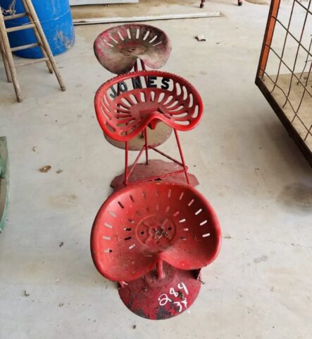 Metal tractor seat stools in upcoming online auction offered by Kiefer Auctioneers in Texas