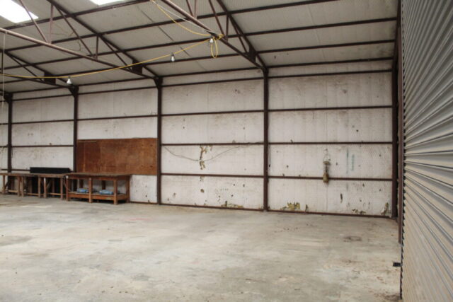 10 acres for sale in Decatur Texas selling by real estate auction with land, shop, and water well in North Texas.