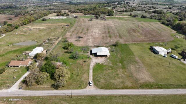 Decatur Texas acreage for sale by auction featuring 10 acres, shop building, water well, and North Texas location.