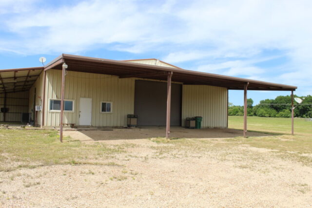 Texas land auction offering 10 acres in Decatur TX with shop, water well, and live onsite auction bidding.