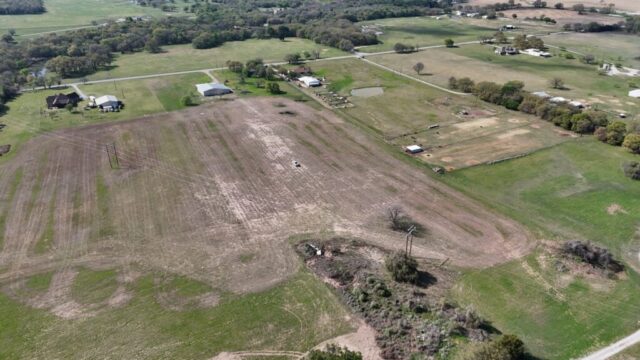 10 acres for sale in Decatur Texas selling by real estate auction with land, shop, and water well in North Texas.