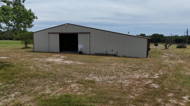 Decatur Texas acreage for sale by auction featuring 10 acres, shop building, water well, and North Texas location.